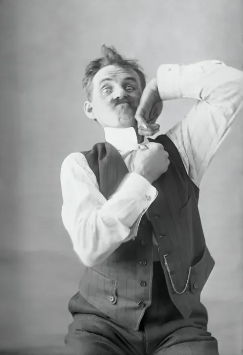 Framed Print : Middle-aged man adjusting collar. August 11, 1925