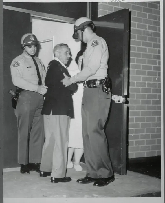 Framed Print : Mike Romanoff Being Escorted by Police Framed Print : Mike Romanoff Being Escorted by Police