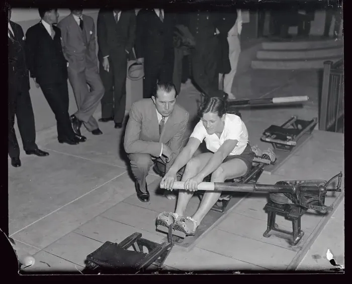 Framed Print : Mildred Didrickson Practicing on Machine with Jack Kelly Alongside Framed Print : Mildred Didrickson Practicing on Machine with Jack Kelly Alongside