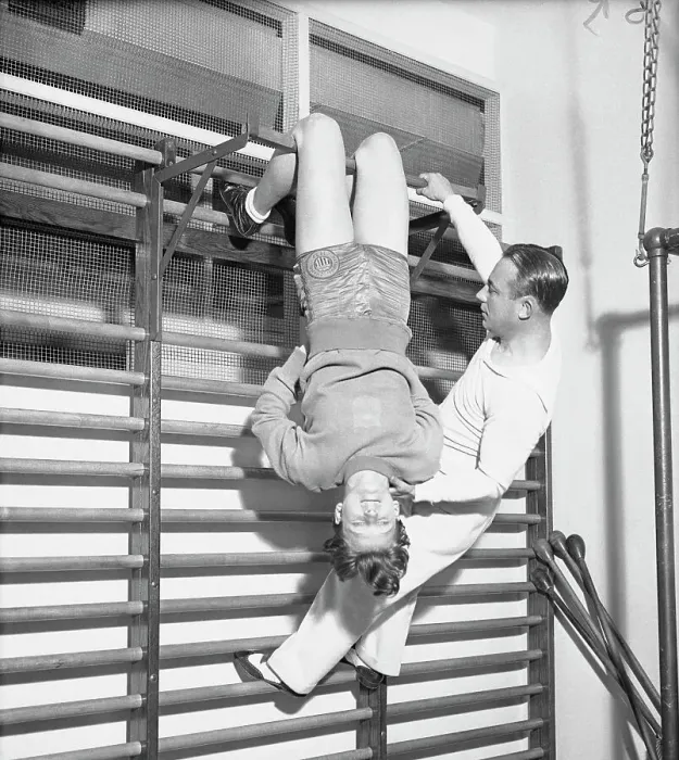 Framed Print : Mildred Didrickson Using Exercise Apparatus with Artie McGovern