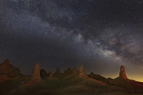 Milky Way and tufa towers of Trona Pinnacles at night, Mojave Desert, California, USA