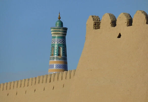 Minaret and old adobe wall of Khiva, Uzbekistan
