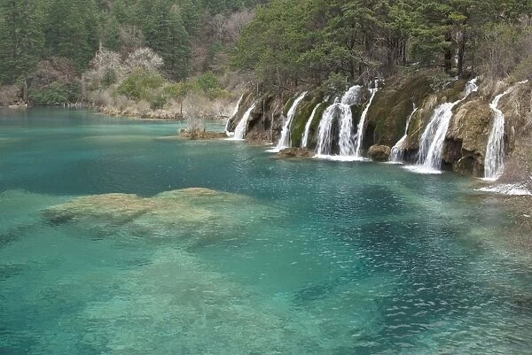Mineral deposits make waterfalls and clear turquoise water of Shuzheng Lakes, Jiuzhaigou National Scenic Area, Sichuan Province, China