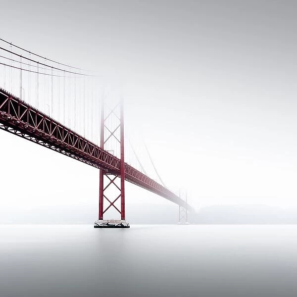 Minimalist long exposure of the Golden Gate Bridge's little sister. The Ponte 25 de Abril bridge over the Tagus River in Lisbon, Portugal