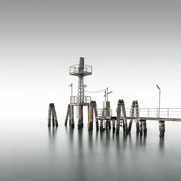 Minimalist wooden footbridge in fog in the Venice Lagoon, Italy