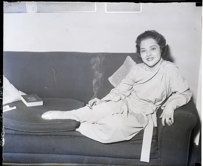 Framed Print : Miriam Battista Seated on Couch Smoking Framed Print : Miriam Battista Seated on Couch Smoking