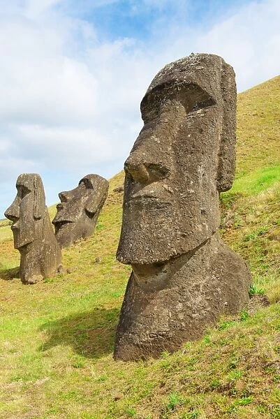 Three moai half buried in a quarry, Easter island