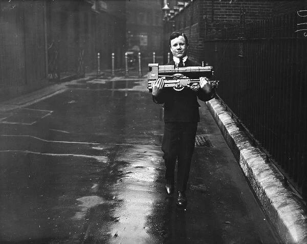 Model Man. 17th April 1928: An exhibitor arriving at Kingsway Hall for