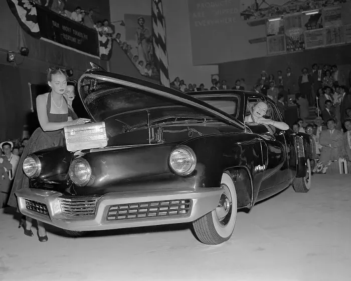 Framed Print : Model Putting Handbag in Front Trunk of Car Framed Print : Model Putting Handbag in Front Trunk of Car