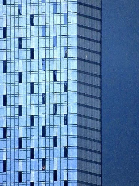A modern corporate building set against a blue sky at dusk