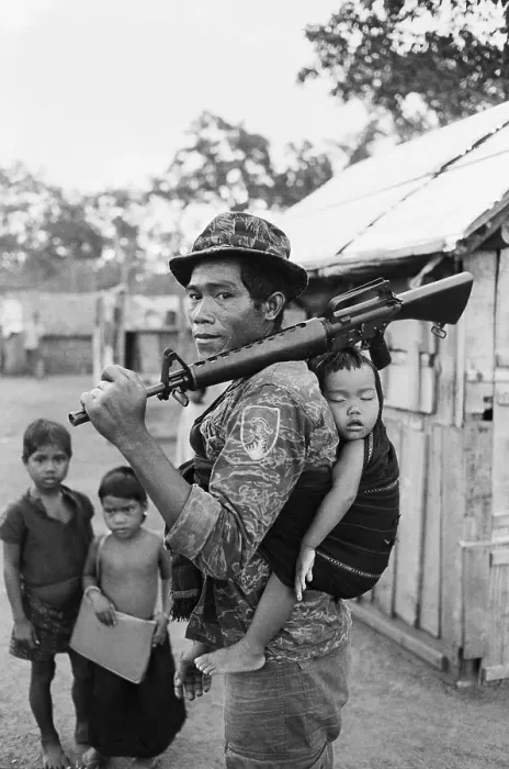 Framed Print : Montagnard Soldier Carrying Baby Framed Print : Montagnard Soldier Carrying Baby