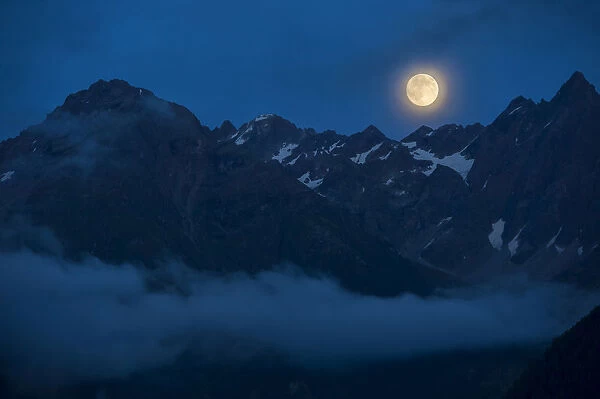 Full moon above the Kaunergrat ridge, Kaunertal valley, Tyrol, Austria