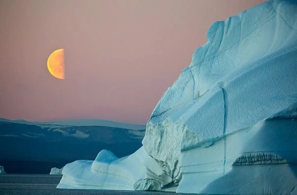 Moonrise. Beautiful moonrise over an iceberg in Greenland
