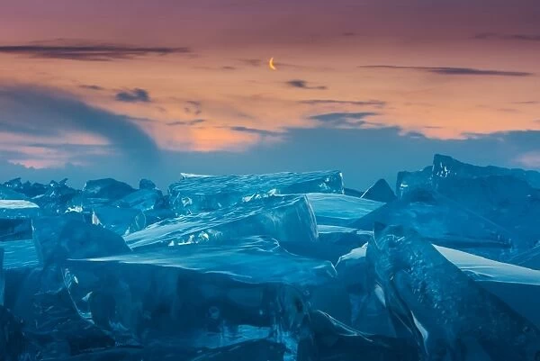 Morning crescent moon at frozen lake