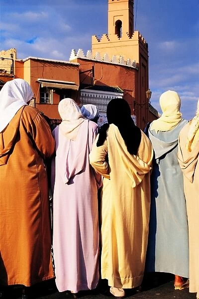 Morocco, Marrakesh, Djemaa El Fna, group of women, rear view