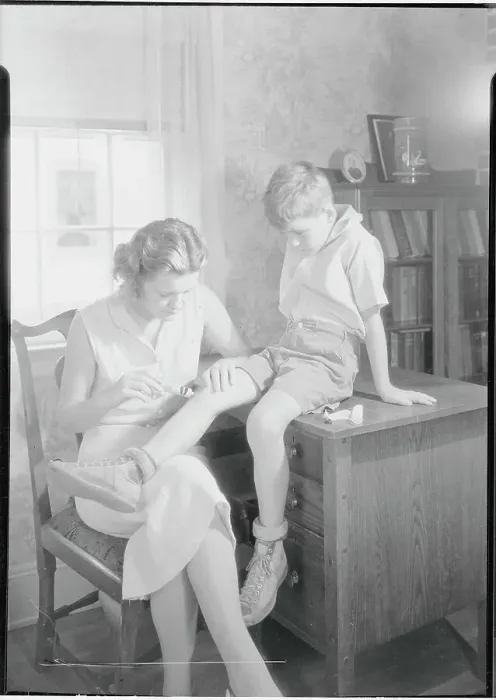 Framed Print : Mother Applying Ointment to Knee Framed Print : Mother Applying Ointment to Knee