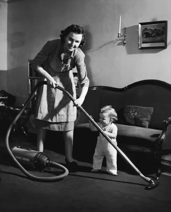 Framed Print : Mother and baby boy (12-15 months) holding vacuum cleaner (B&W) Framed Print : Mother and baby boy (12-15 months) holding vacuum cleaner (B&W)
