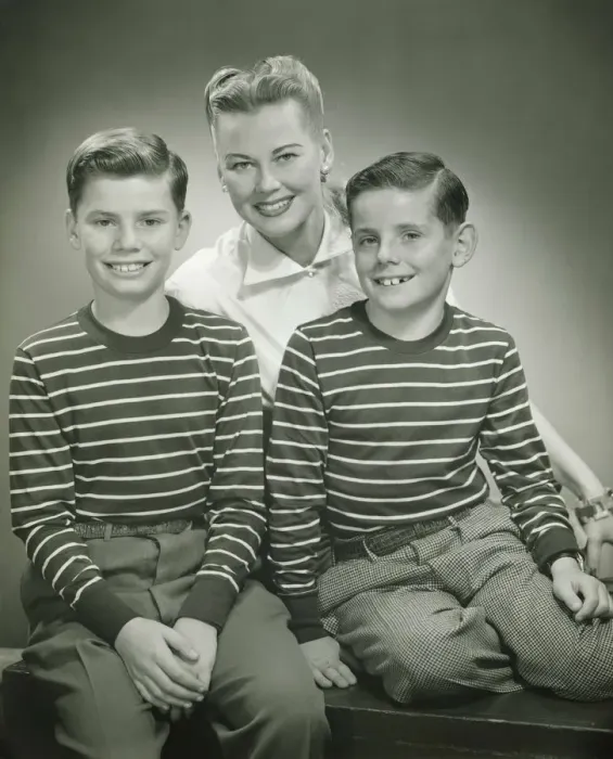 Framed Print : Mother with brothers (8-9) (10-11) sitting in studio, smiling, (B&W), portrait Framed Print : Mother with brothers (8-9) (10-11) sitting in studio, smiling, (B&W), portrait