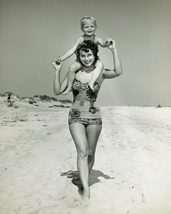Framed Print : Mother carrying son (2-3) on shoulders, walking on beach, (B&W), portrait Framed Print : Mother carrying son (2-3) on shoulders, walking on beach, (B&W), portrait