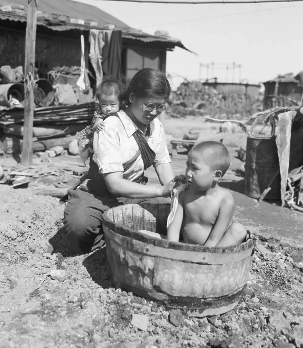 Framed Print : Mother with Child on Back Bathes Other Child Framed Print : Mother with Child on Back Bathes Other Child