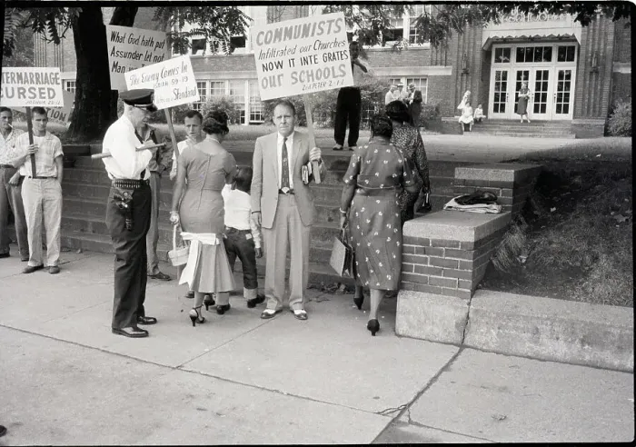 Framed Print : Mother and Child Walking Past Protestors Framed Print : Mother and Child Walking Past Protestors