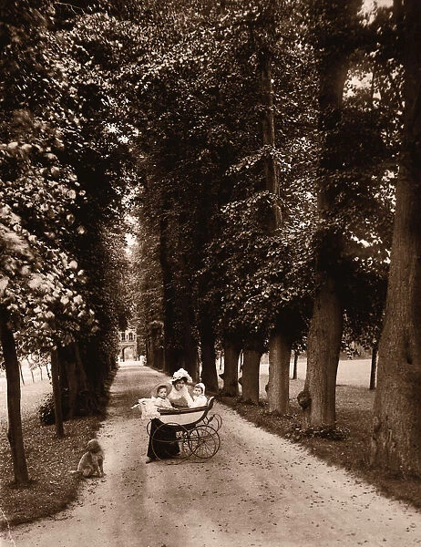Mother with children (6-24 months) in carriage on path (B&W sepia)