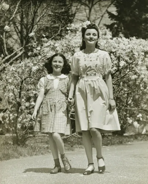 Framed Print : Mother and daughter (8-9) strolling in park, (B&W) Framed Print : Mother and daughter (8-9) strolling in park, (B&W)