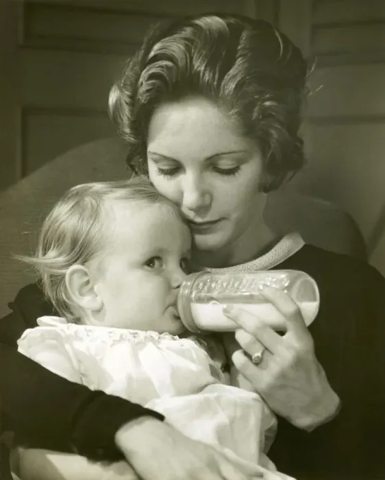 Framed Print : Mother feeding baby girl Framed Print : Mother feeding baby girl