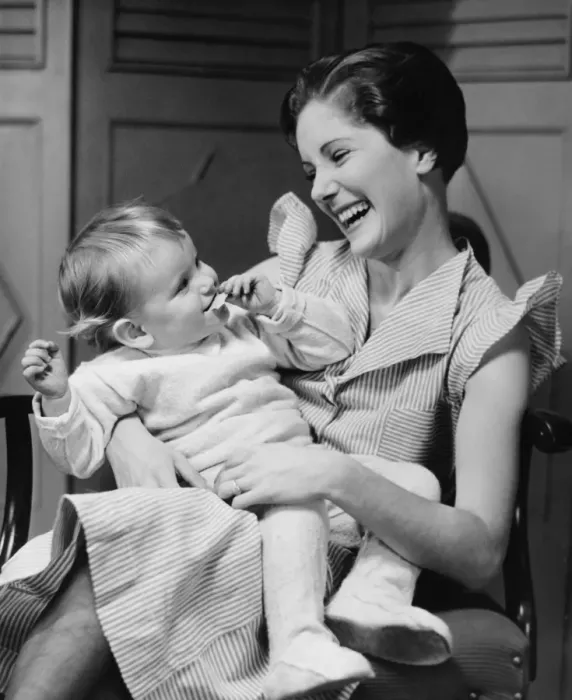 Framed Print : Mother laughing with child (6-12 months) on laps, (B&W) Framed Print : Mother laughing with child (6-12 months) on laps, (B&W)