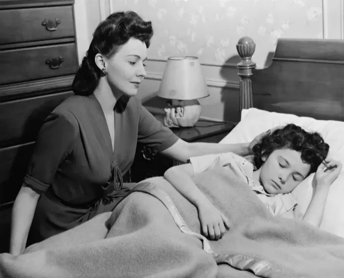Framed Print : Mother looking at sleeping daughter (8-9), (B&W) Framed Print : Mother looking at sleeping daughter (8-9), (B&W)