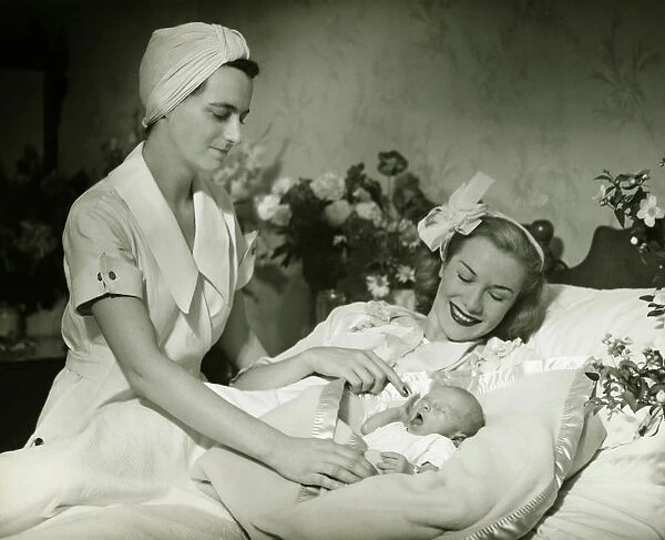 Mother lying in bed smiling to baby-child (0-6 months), nurse standing beside, (B&W)