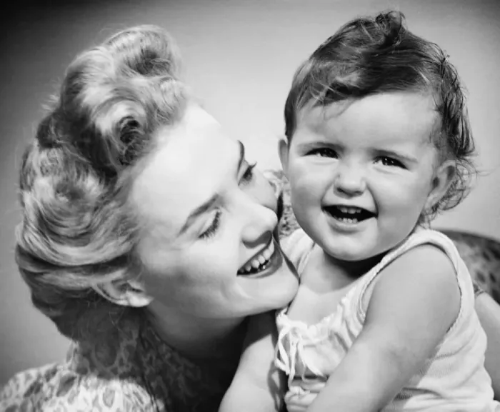 Framed Print : Mother smiling to baby girl (12-18 months), (B&W), close-up