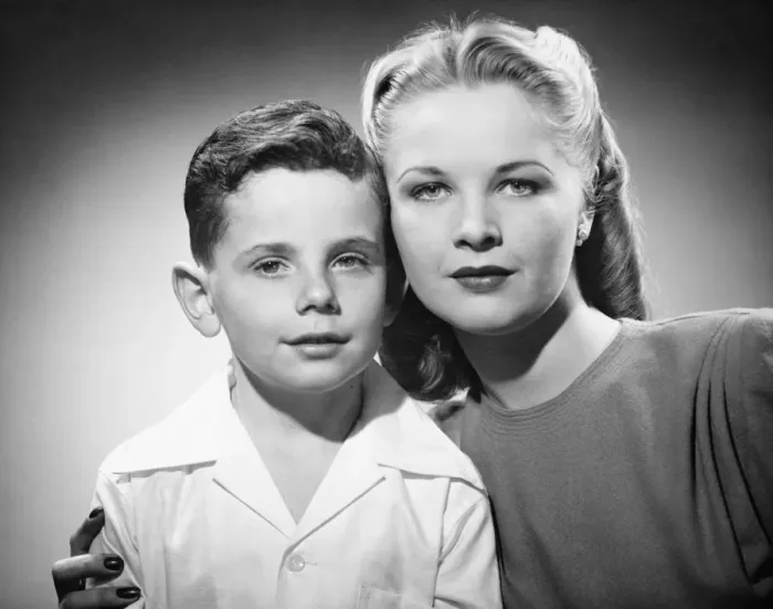 Framed Print : Mother with son (6-7) posing in studio, (B&W), portrait Framed Print : Mother with son (6-7) posing in studio, (B&W), portrait