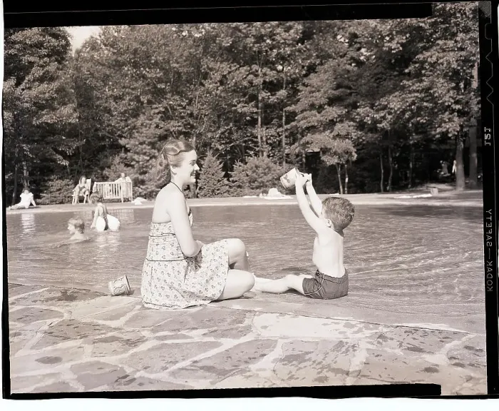 Framed Print : Mother and Son Playing Beside Wading Pool Framed Print : Mother and Son Playing Beside Wading Pool