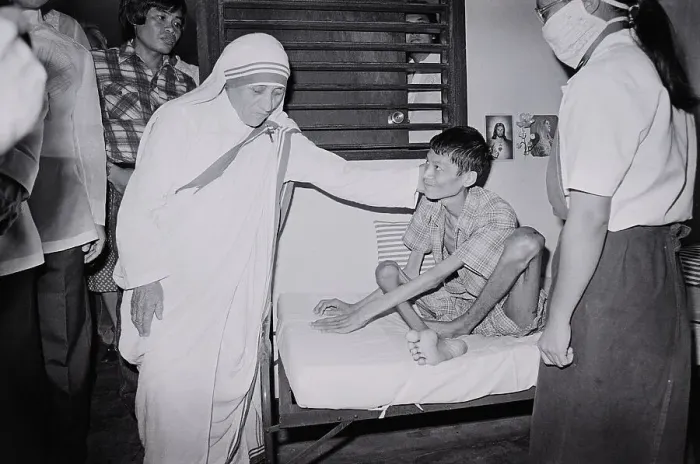 Framed Print : Mother Teresa Comforts Polio Victim Framed Print : Mother Teresa Comforts Polio Victim