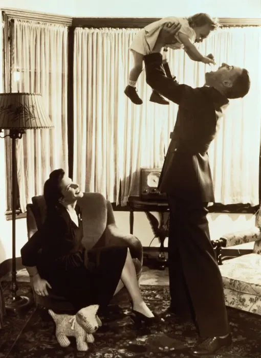 Framed Print : Mother watching father lifting toddler (18-21 months) (B&W sepia tone)