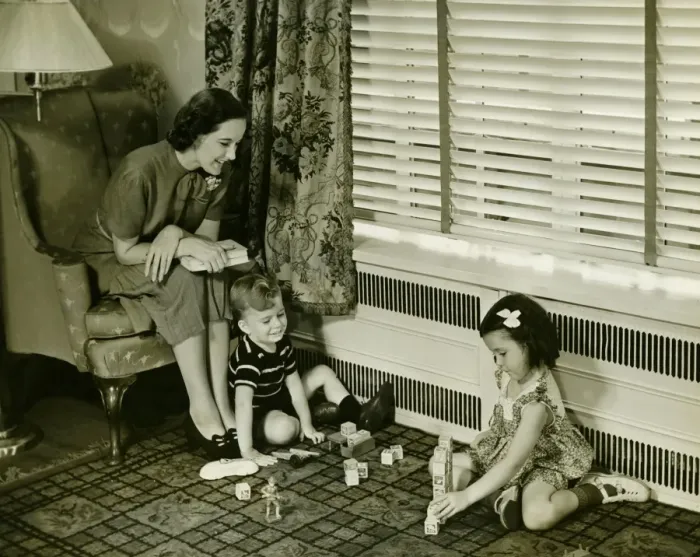 Framed Print : Mother watching over son and daughter (4-5) playing in living room, (B&W) Framed Print : Mother watching over son and daughter (4-5) playing in living room, (B&W)