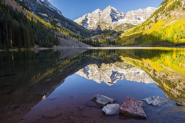 Mountain lake reflections in autumn sunrise, Maroon Bells, Colorado, USA