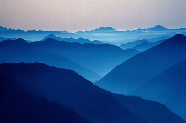 Mountain peaks shrouded in blue mist