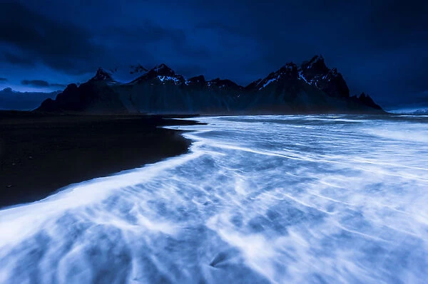 Mountain peaks and surf, blue hour, Hofn, Iceland