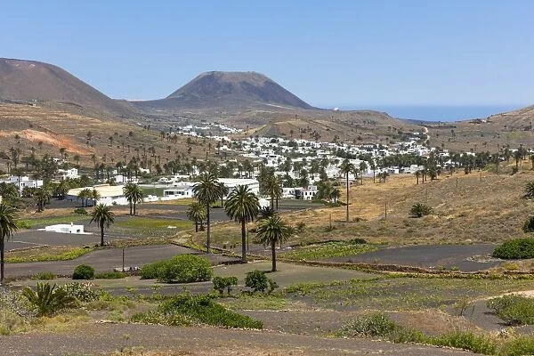 The mountain village of Haria, with its white houses, the volcano Monte Corona at the back, Maguez, Lanzarote, Canary Islands, Spain
