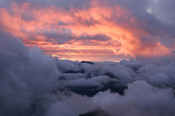 Mountains shrouded in clouds at sunset, Arlberg, Vorarlberg, Austria, Europe