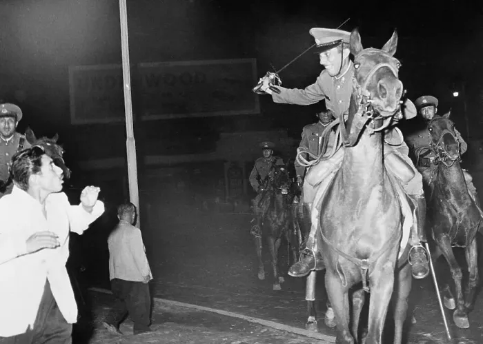 Framed Print : Mounted Policeman Swings Sword at Rioter Framed Print : Mounted Policeman Swings Sword at Rioter