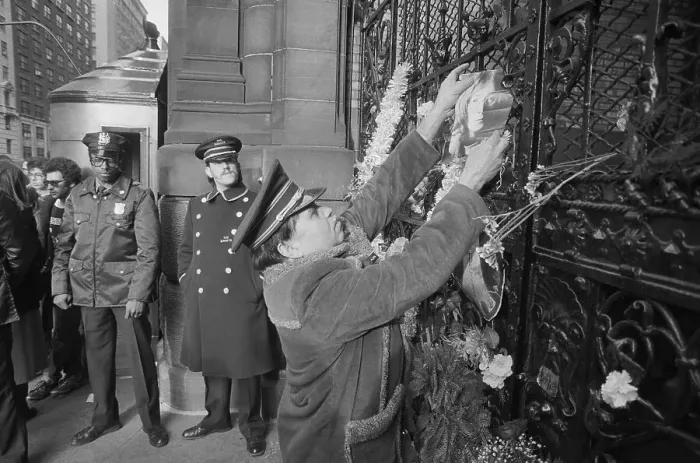 Framed Print : Mourner Affixing Photo to Door Framed Print : Mourner Affixing Photo to Door