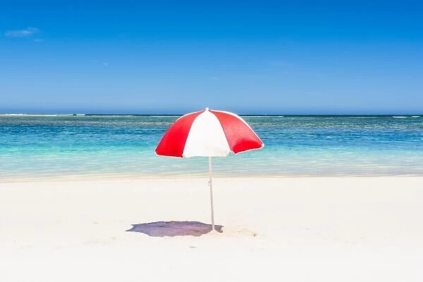 A multicolored beach umbrella on the shore. Western Australia