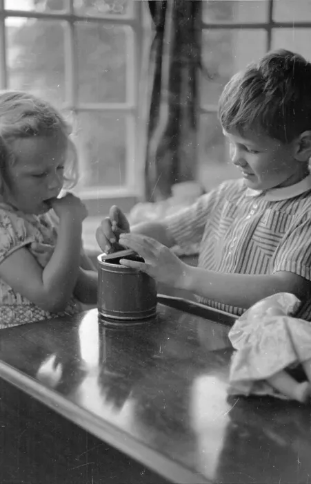Framed Print : Music Box. 24th July 1948: Children playing with a tin can musical box Framed Print : Music Box. 24th July 1948: Children playing with a tin can musical box