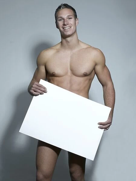 Naked man holding a blank sign in his hands