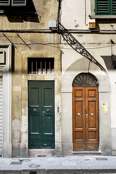 Narrow heavy wooden front doors to residential buildings, Florence, Italy