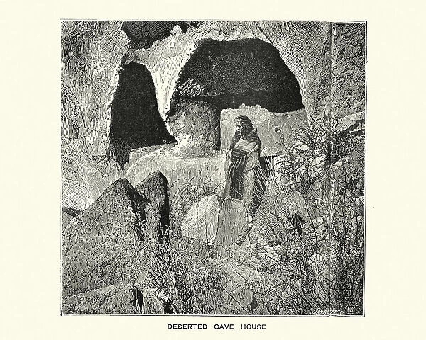 Native American woman outside a deserted cave dwelling