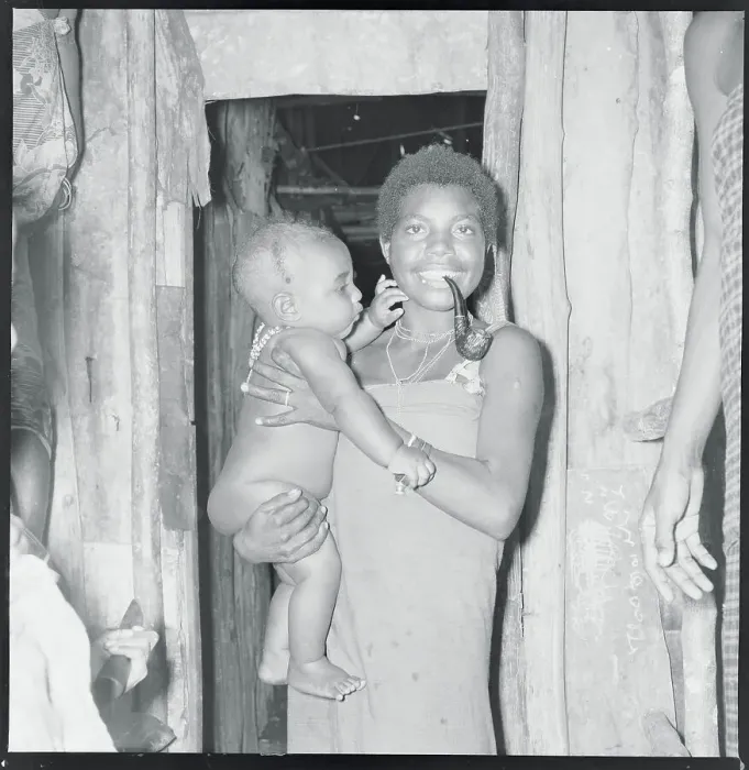 Framed Print : Native Woman with Baby Inside Hut Framed Print : Native Woman with Baby Inside Hut